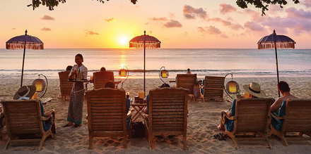 Romantischer Sonnenuntergang am Traumstrand von Bali, dem Jimbaran Beach